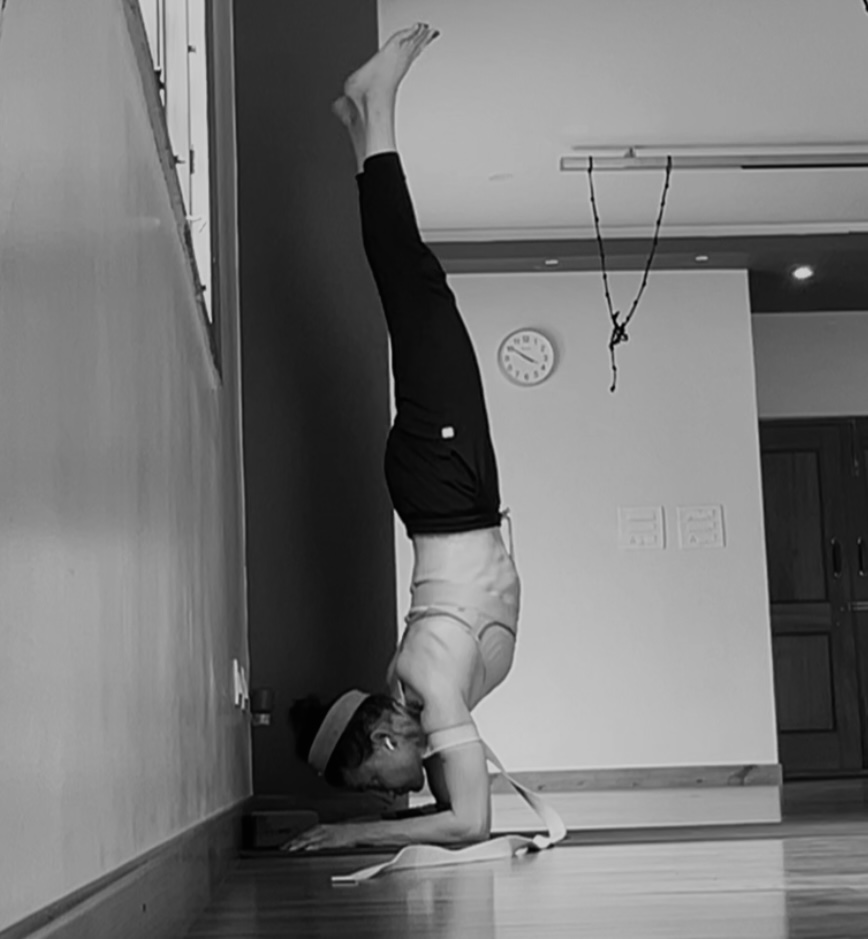Practitioner in a deep backbend, pelvis loaded in extension